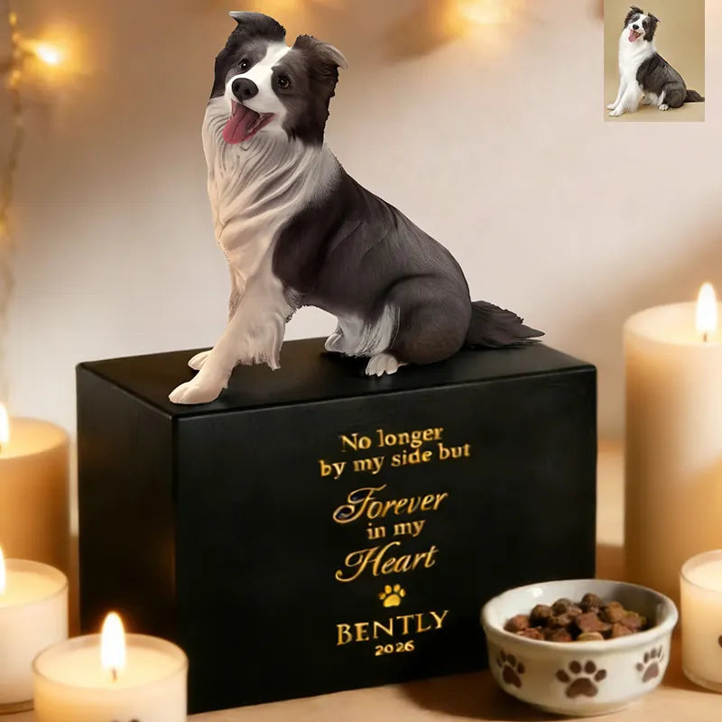 A lifelike 3D black-and-white dog sculpture sits atop the PawPrint Dog Urn engraved with “No longer by my side but forever in my heart, Bently 2026,” surrounded by candles and kibble. An inset photo features the real dog.