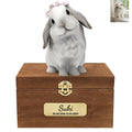 The Bunny Sweet Memories features a white and gray rabbit with a pink bow on a wooden box engraved "Suki 03.08.2018–12.03.2024," plus a small photo of the real bunny in the top right corner.