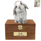 The Bunny Sweet Memories features a white and gray rabbit with a pink bow on a wooden box engraved "Suki 03.08.2018–12.03.2024," plus a small photo of the real bunny in the top right corner.